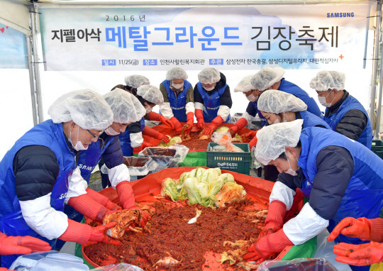 삼성전자는 지난 25일 인천 사할린 동포 복지회관에서 삼성 지펠아삭 김치냉장고와 함께하는 '메탈그라운드 김장축제'를 열었다고 27일 밝혔다. 대한적십자사와 함께 사회공헌활동의 일환으로 진행된 이번 김장축제에는 삼성전자 임직원 100명이 참여해 지펠아삭 M9000을 상징하는 9000포기의 김장김치를 마련했다. <삼성전자 제공>
